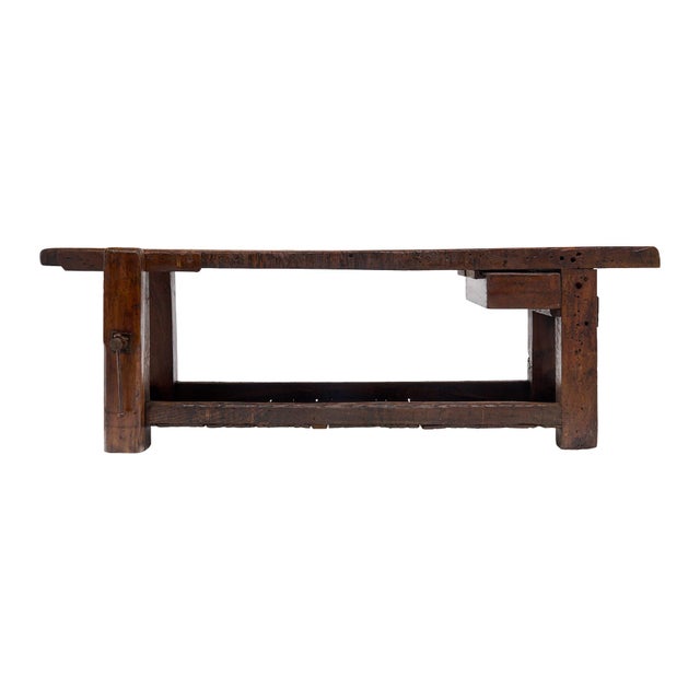 Workbench from the French Alps made of waxed and patinated chestnut wood. The bench features the original vise and clamp...