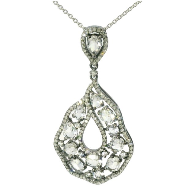 Exquisite 14K White Gold Diamond and White Topaz Drop Pendant. This stunning piece features 12 white topaz gemstones in...