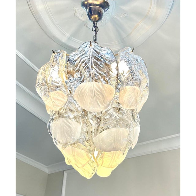 Stunning Murano glass chandelier. The glass is hand-cut into leaf shapes. This chandelier features a gold-plated metal...