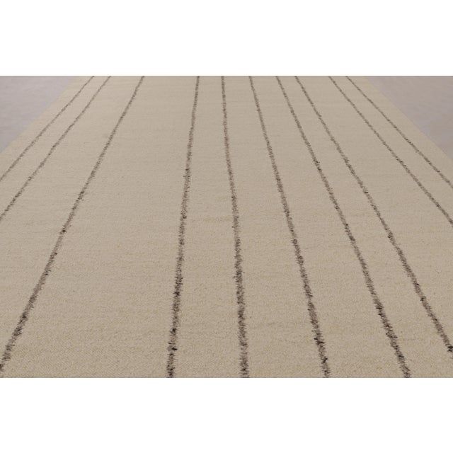 Handwoven in wool and cotton, this 12x18 contemporary oversized flatweave is an exciting new addition to Rug & Kilim’s...