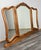 A graceful vintage French triple dressing mirror , framed in richly polished oak with flowing curves and carved shell...