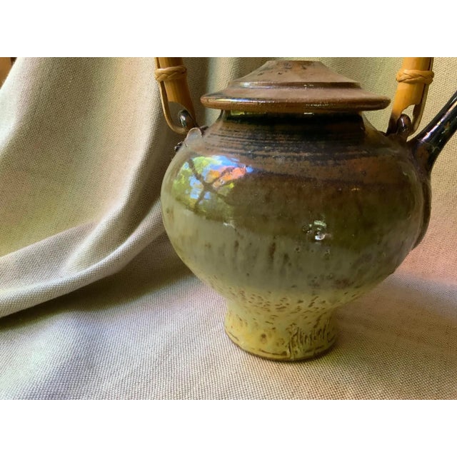 A Gem of Mid-Century Design: Large Asian-inspired glazed stoneware lidded teapot with bamboo handle by internationally...