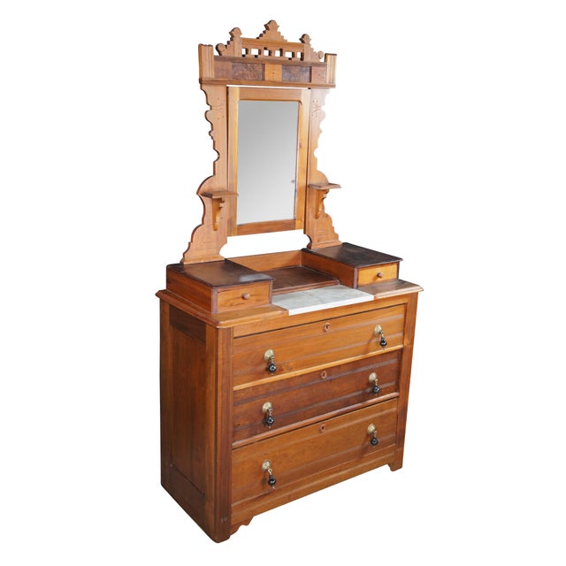 A beautiful Late Victorian Eastlake Dresser and Mirror, circa 1880. The case is made from walnut with three lower drawers...