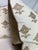 Custom pair of 22" pillows covered in Schumacher "Rubia Embroidery" in ivory and backed in a coordinating bronze cotton...