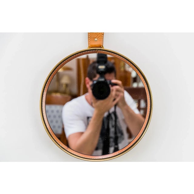 - Wall mirror with leather - Produced around the 1950s - Original condition