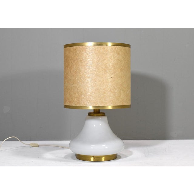 1970’s Italian table lamp in Opaline glass and brass details. The bottom and top of the lamp can be turned on and off...