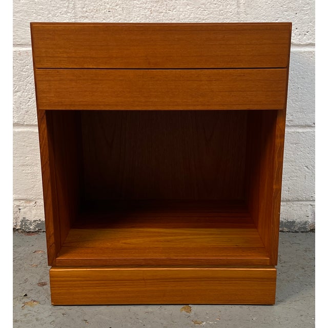 Beautiful mid-century modern Danish teak nightstand featuring clean minimalist lines and the warm, richly grained...