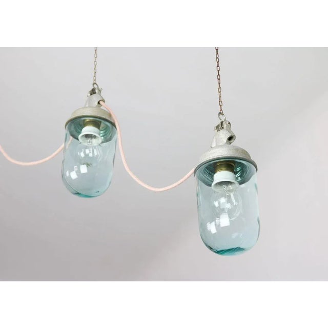 Vintage Industrial Blue Glass and Grey Metal Pendant Lamps, 1950s, Set of 2, in Very Good conditions. Designed 1950 to...