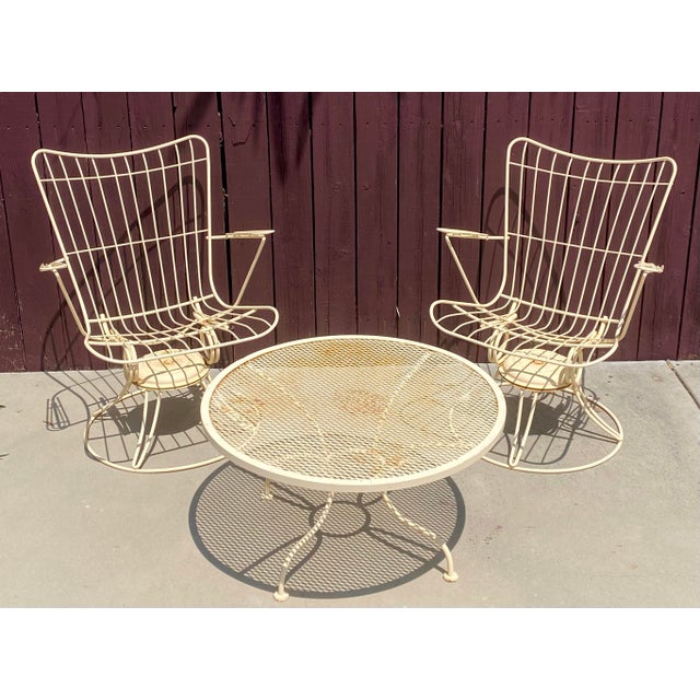 A pair of welded steel outdoor patio swivel rockers and round low table by Homecrest. These #36 Carousel Swivel Rocking...