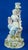 Item : A magnificent hard-paste porcelain candlestick featuring a central woman, depicting the muse of poetry, embellished...