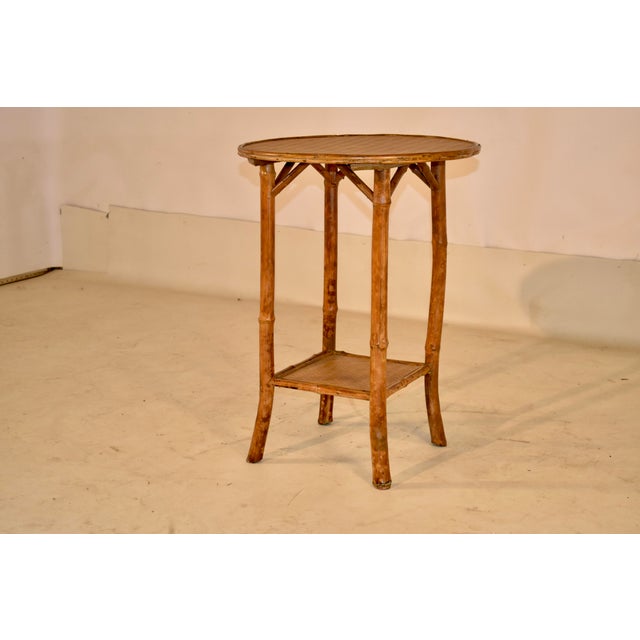 19th century round bamboo side table from France. The top has a lovely bamboo molding surrounding a basketweave pattern...