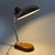 An iconic and functional adjustable desk lamp with an industrial design, attributed to the Italian manufacturer Seminara...