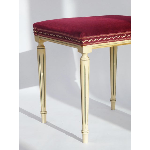 A French Louis XVI style velvet foot stool made out of wood with a nice velvet red surface with embroidered details. A...