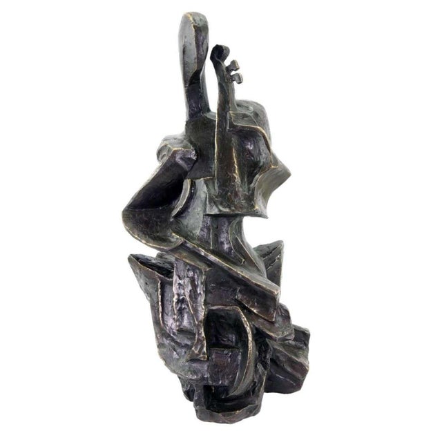 Modern cubist bronze cello player sculpture with a dark patinated finish, inspired by early 20th-century Cubism and...