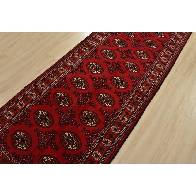 An authentic vintage tribal Turkmen runner, hand-knotted with fine wool and natural dyes. This nomadic rug features rows...