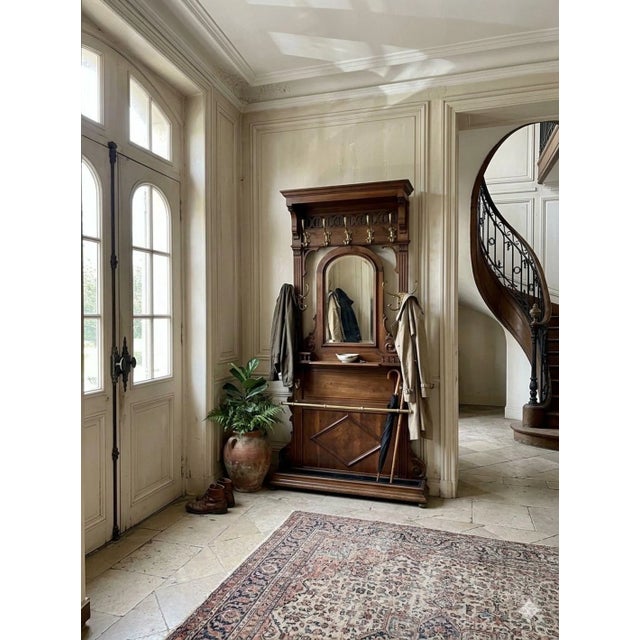 French charm and a sense of history are apparent with this antique hall tree. Featuring brackets with finials supporting...