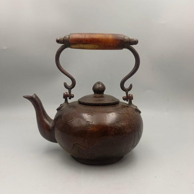 This exquisite piece features a classic bulbous body made of copper with a rich, aged patina finish. The surface is...
