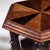 This is an early 20th century Anglo-Indian carved elephant form drinks table with sunburst parquetry top. There are three...