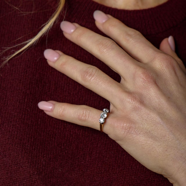 This Victorian three stone ring is a beautifully restrained expression of turn-of-the-century romance and craftsmanship....