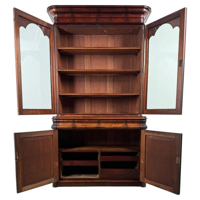 A magnificent 19th-century English bookcase on cupboard, finely crafted from mahogany and distinguished by its impressive...