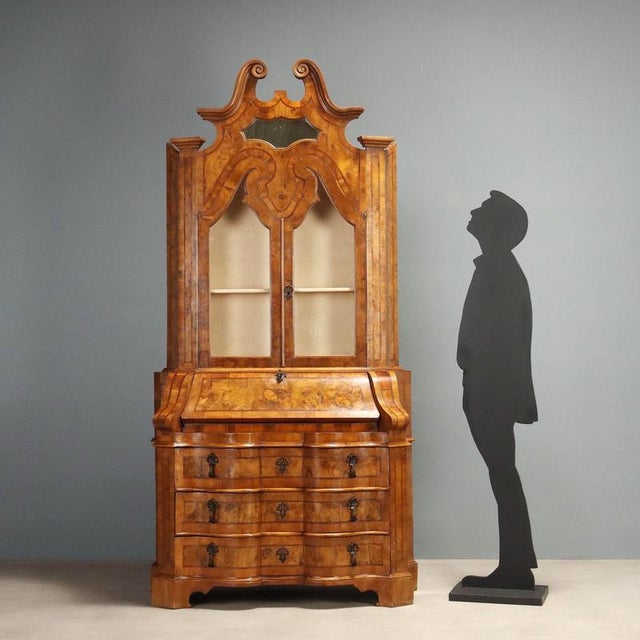 Walnut and burl walnut trumeau, crafted in Italy in the first half of the 20th century. The structure features an elegant...