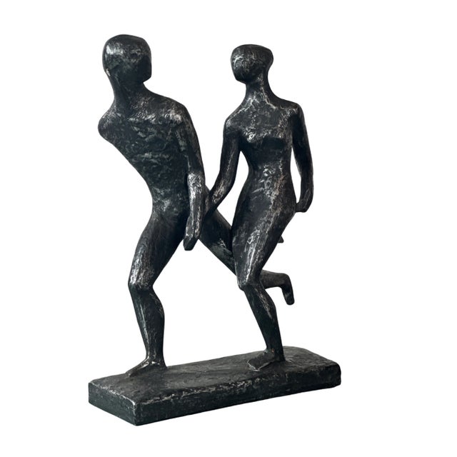 Textured Vintage statue in silver and black by Austin Products shows a couple amid a run, with hands held. This fluid yet...