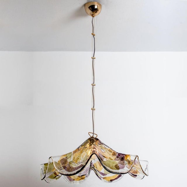 A colorful hand blown pendant of murano glass. Made in murano, italy around 1980. The glass is original hand blown murano...