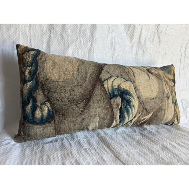 An exquisite 16th-century Brussels tapestry fragment transformed into a refined decorative pillow. Woven in wool and silk,...