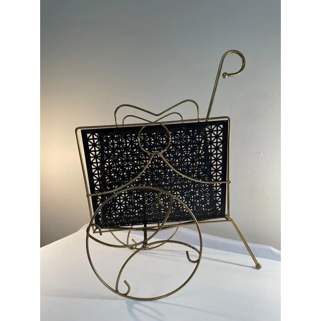 A very unique Mid Century Modern Magazine Rack Cart with working wheels. Circa 1950s. The brass wheels and handle make...