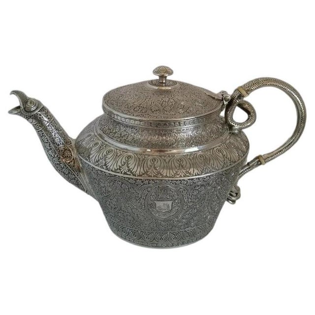 A fine quality 19th-century high-grade silver teapot and matching sucrier, richly decorated with hand-chased repoussé work...