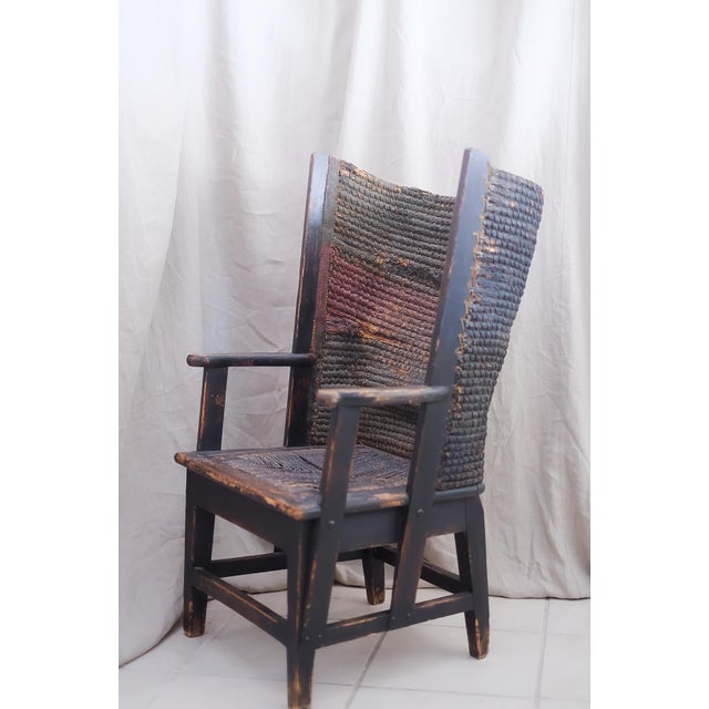 The Orkney chair has an oak frame supporting a back in the style of handwoven straw wingback. The wooden base with...