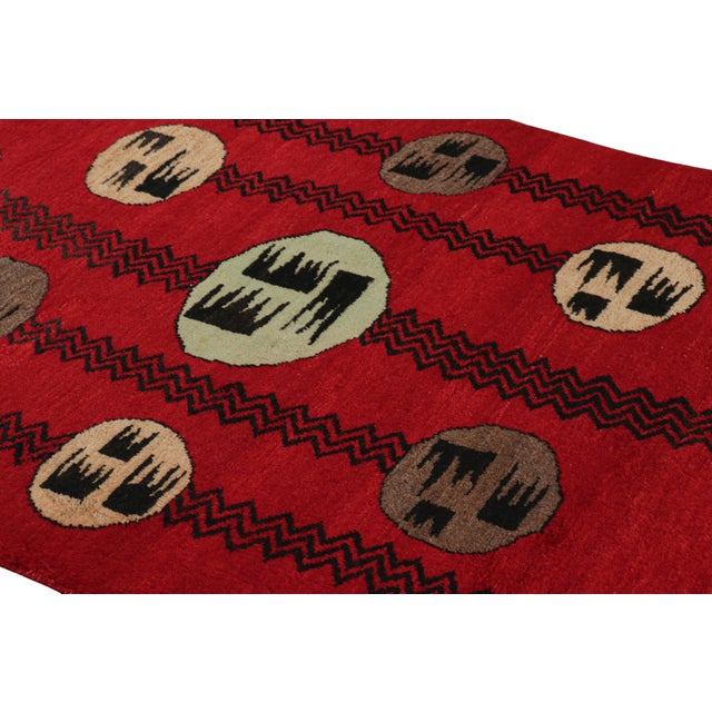 Hand-knotted in wool circa 1960-1970, this 4x7 vintage rug from Turkey is a very special piece, featuring a mid-century...