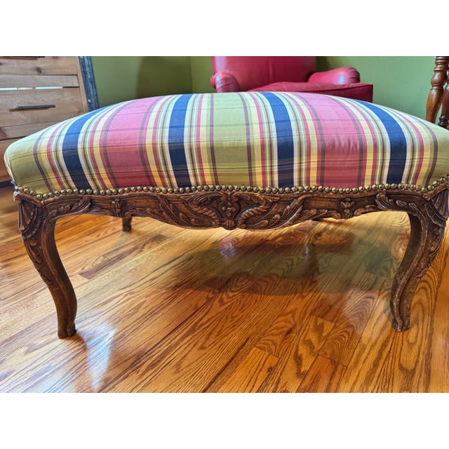 The Louis Quinze Style walnut ottoman having a rectangular upholstered cushion above the conforming frame of walnut...