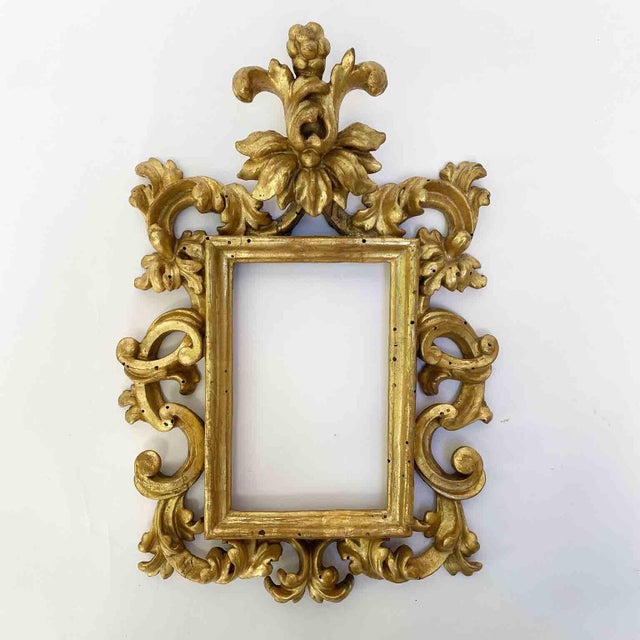 A pair of antique Italian carved and gilded frames dating back to the 18th century from central Italy. Crafted from a...