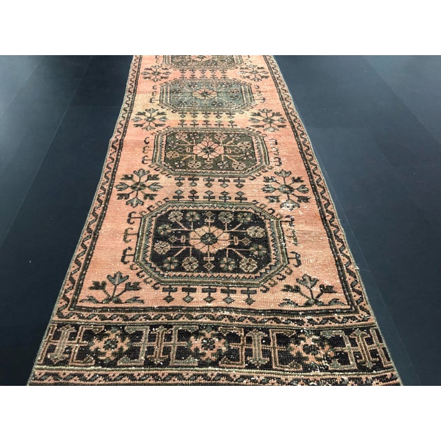 This is a vintage faded wool rug. The piece was handmade in Turkey in the '70s.