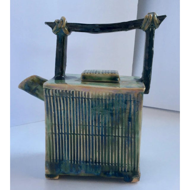 Amazing craftsmanship in this wonderfully detailed and textured hand-made porcelain teapot in an unusual square slab...