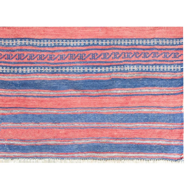 This early 20th-century Afghani Sumac rug features a deceptively simple yet intricately woven geometric design, with...