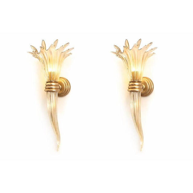 Extraordinary pair of wall sconces dating to the 1940s, crafted in pure Murano glass. The finely silvered structure...
