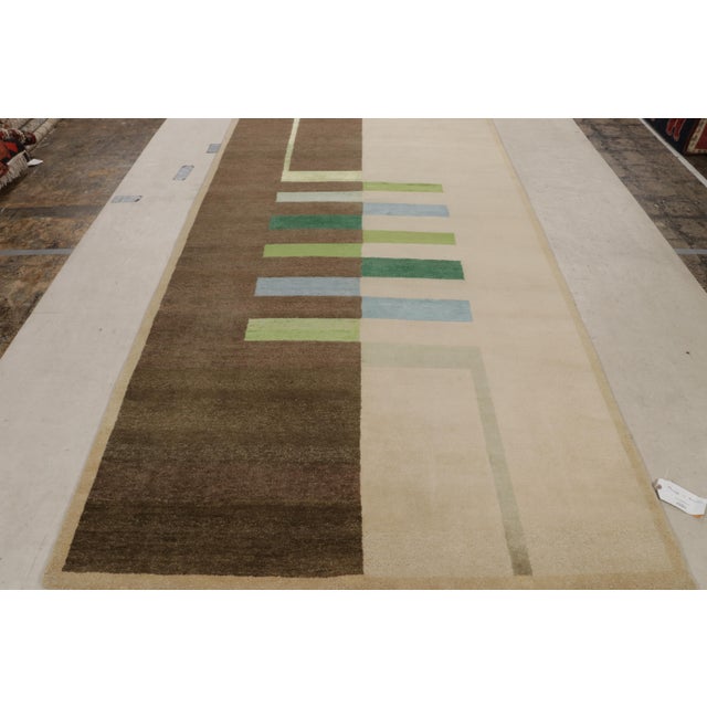 This mid-century geometric wool and silk rug from Rug & Kilim’s custom mid-century modern collection has a Bauhaus design,...