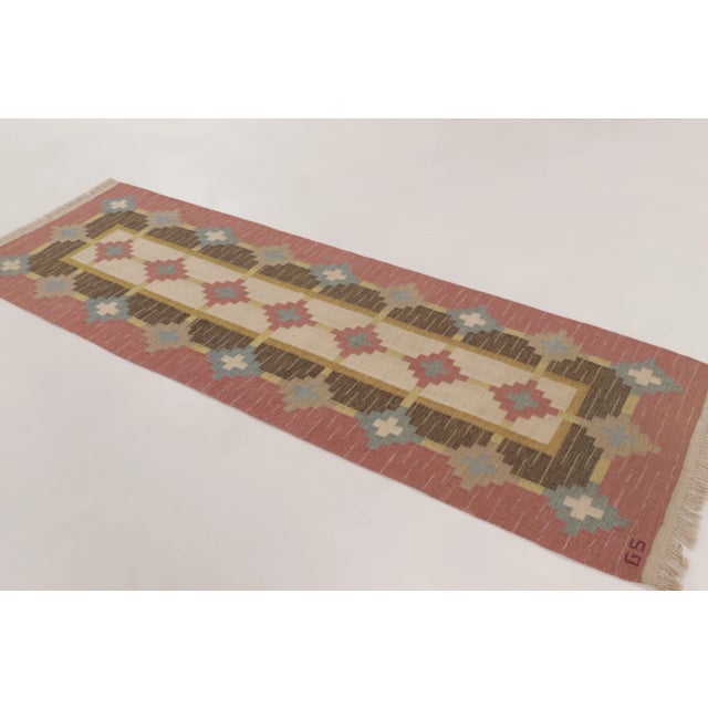 Handwoven in wool circa 1950–1960, this 3x10 vintage Swedish rölakan runner reflects a refined interpretation of Nordic...