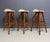 This elegant trio of mid-century bar stools, designed by Danish furniture maker Eric Buch, showcases the sculptural...
