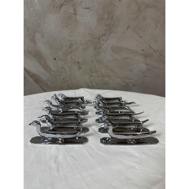 A charming complete set of 12 silvered bronze knife rests dating from the 1950s, produced under the registered trademark...