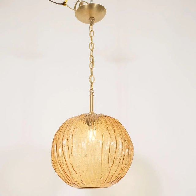 Amber textured glass pendant. In the Manner of: Kalmar Origin: Austria Circa: 1960s Materials: glass Capacity: 1 x E26...