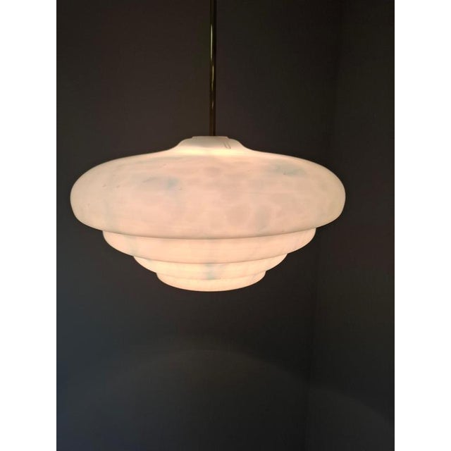 This elegant midcentury modern pendant lamp was produced by napako in czechoslovakia during the 1970s. The design features...
