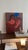 This contemporary figurative painting explores the understated beauty of human connection. Through simplified forms and a...