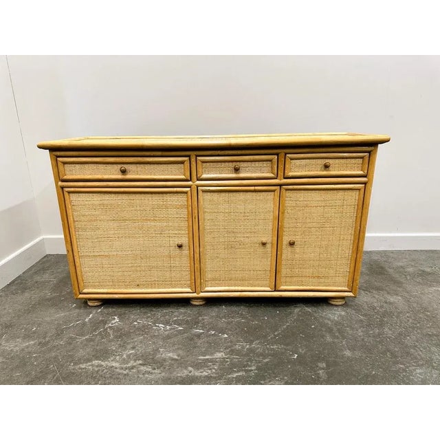 Width: 155 centimeters Height: 88 centimeters Depth: 47 centimeters Elegant bamboo and rattan sideboard with three doors...