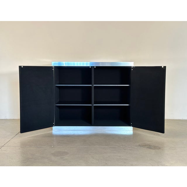 Sideboard designed by Guido Faleschini for Hermes in the 70s, wooden frame lined in black felt, steel profiles, black...