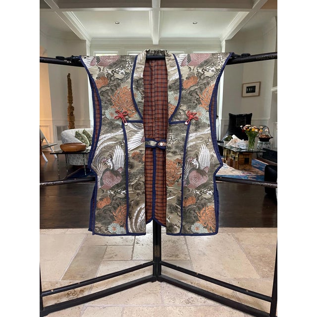 Made entirely from luxuriant woven brocade (kinran) for the exterior, this Japanese sleeveless jacket is called Jinbaori....