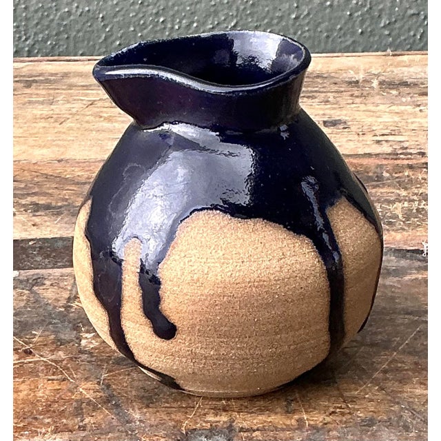 Elevate your tabletop or shelving display with this exquisite original studio pottery pitcher, a testament to the organic...