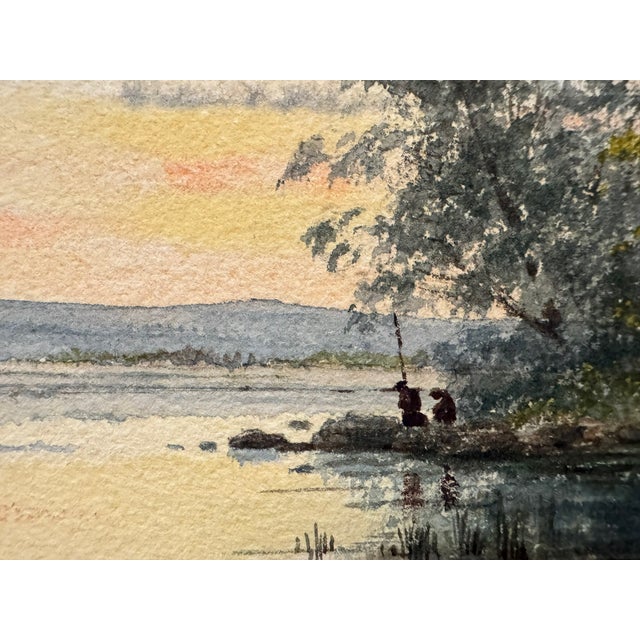 Original watercolor on paper depicting a tranquil river or marsh landscape at sunset, with reflective water, reeds, mature...